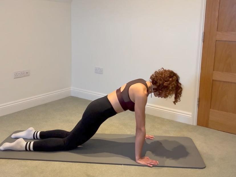 Sandra performing an exercise on mat